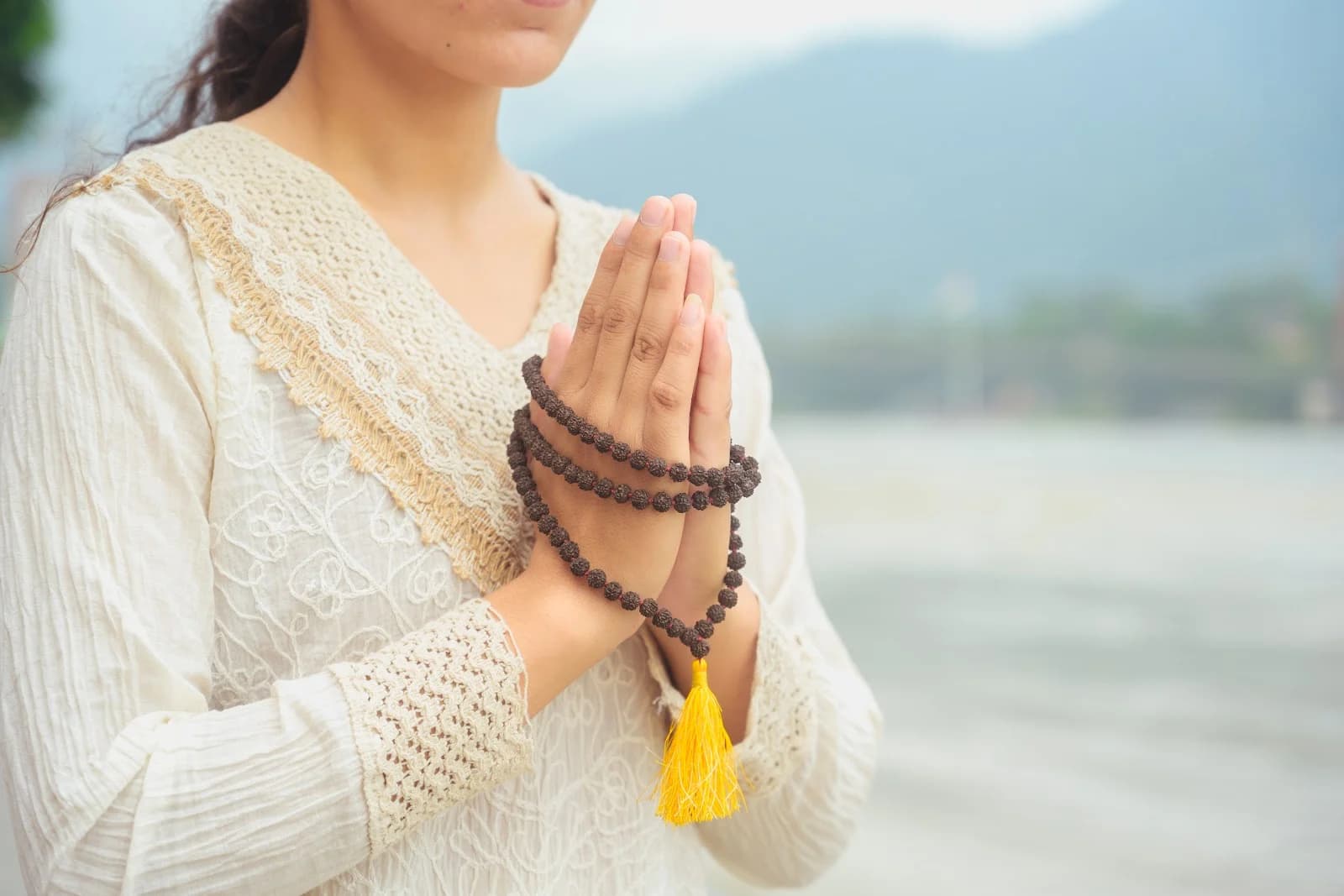 Praying hands with rudraksha mala