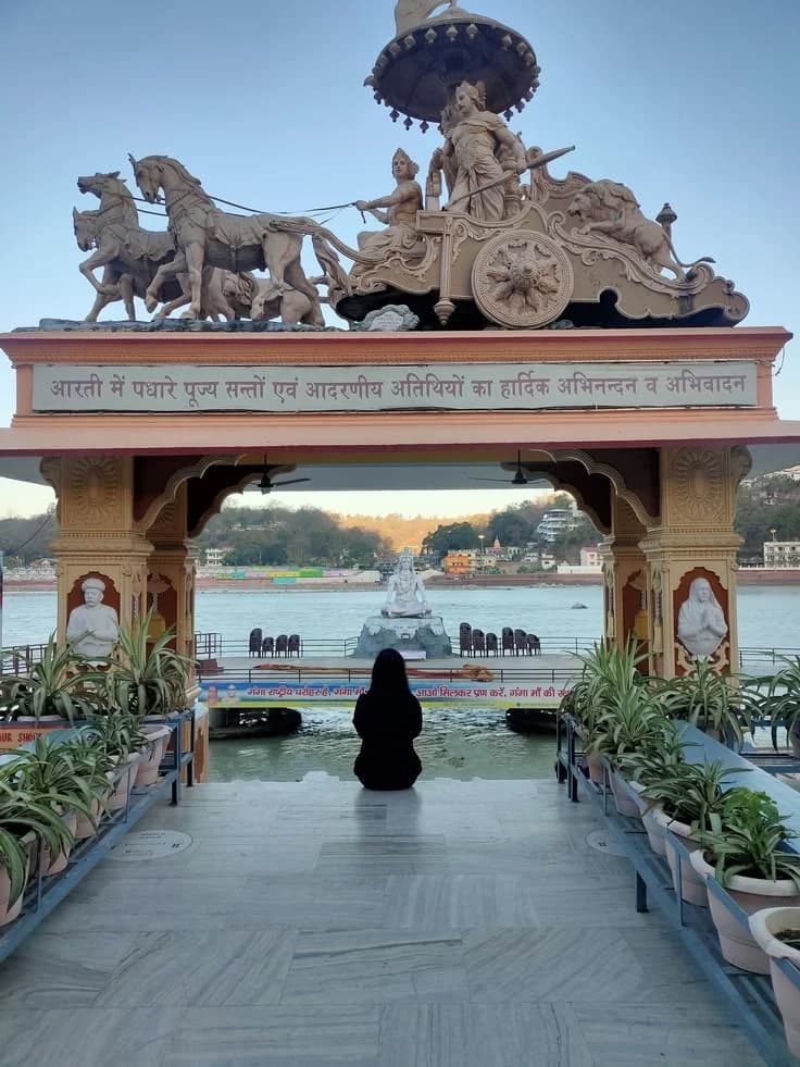 Meditation at Ganga Ghat overlooking Shiva statue in Rishikesh